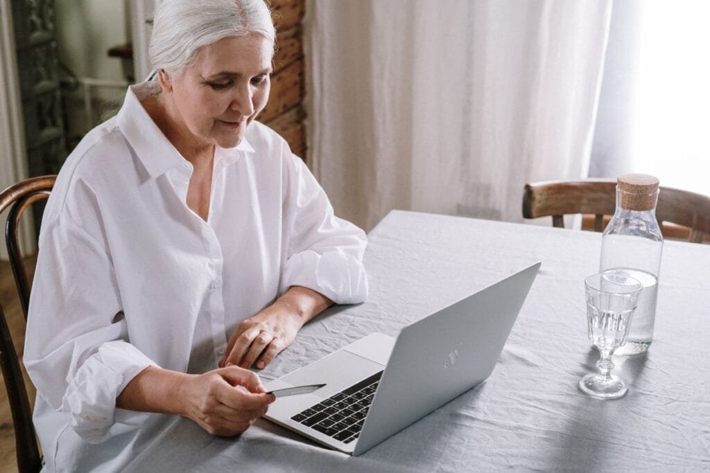 Home Care Local Citations: Senior-Care Directories That Bring Leads 3 An older woman using a laptop to compare home care agencies on senior-care directories