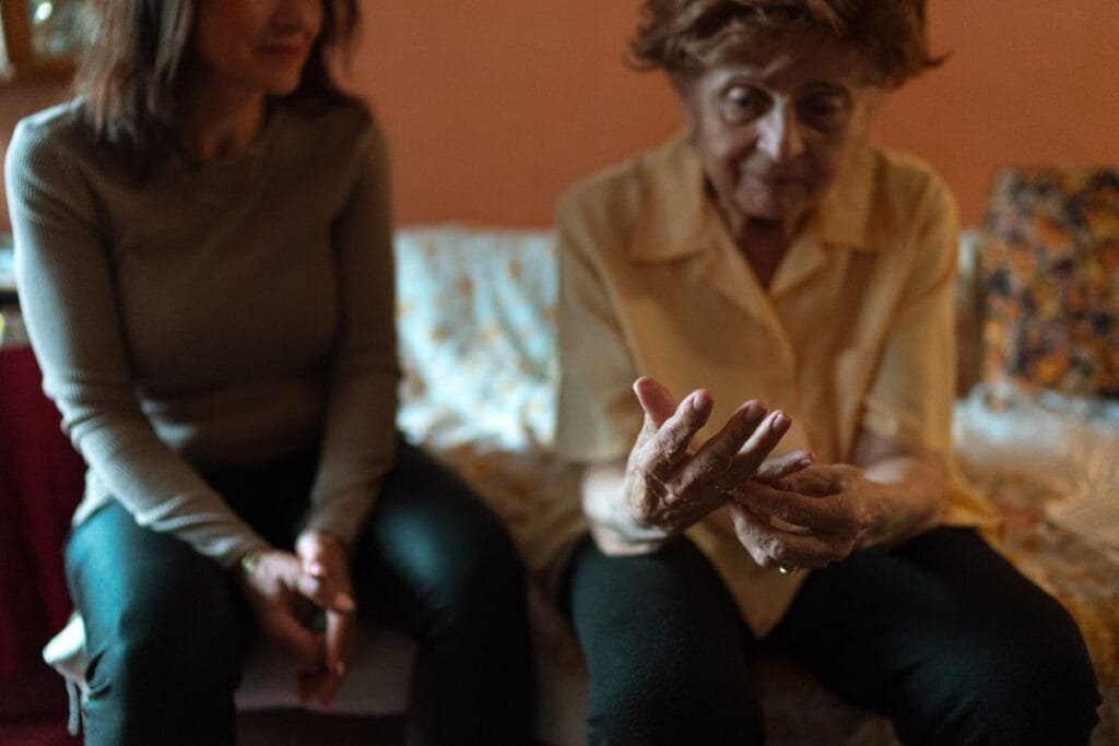 A caregiver sitting with a senior client, the kind of care that earns genuine home care reviews